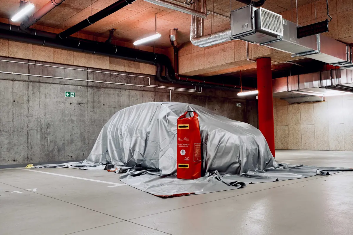 WINGS fire blanket spread over a car in an underground garage